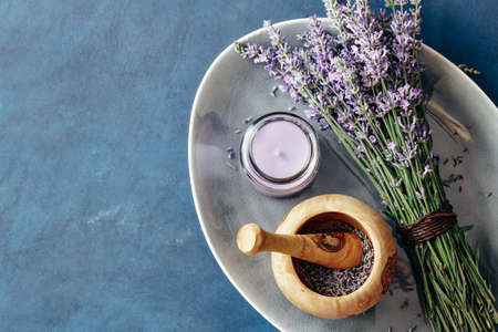 Fresh bundle of lavender and wooden mortar with lavender flowers. Top view. Copy space.の写真素材