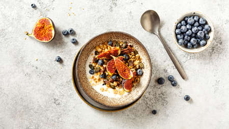 Granola with yogurt, berries and fresh figs. Healthy breakfast.の写真素材