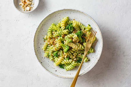 Pasta with green pesto sauce and broccoli. Top view.の写真素材