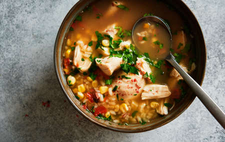 Homemade chicken soup with vegetables and rice in bowlの写真素材