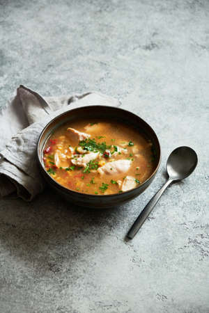 Homemade meat soup with vegetables and rice in bowl. Copy space.の写真素材