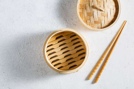 Empty bamboo steamer on whiteの写真素材
