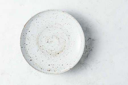 Ceramic plates on a light background, top view.の写真素材