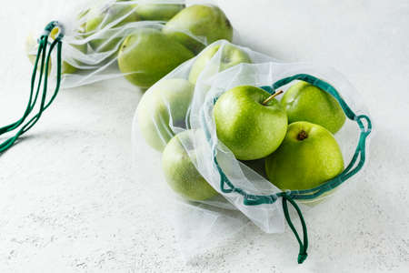 Fresh apples in reusable bags. Zero waste concept. Top view.の写真素材