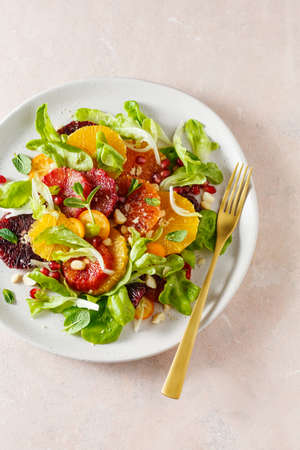 Fruit salad with blood oranges, nuts and pomegranate seeds. Top view, copy space.の写真素材