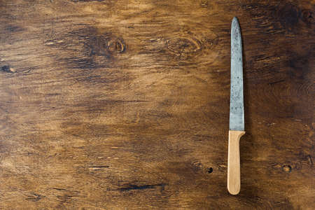 Vintage old knife on wooden boardの写真素材