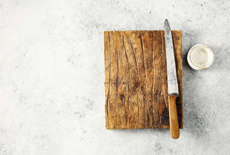 Vintage old knife and Empty cutting Board on greyの写真素材