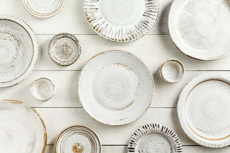 Set of modern ceramic dishes on a white wooden background. Top view, Flat lay.の写真素材
