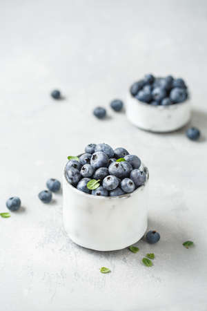Fresh blueberries on a small ceramic bowl. Selective focusの写真素材