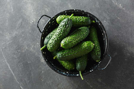 Raw organic cucumbers in a bowl. Organic vegetables, top view.の写真素材