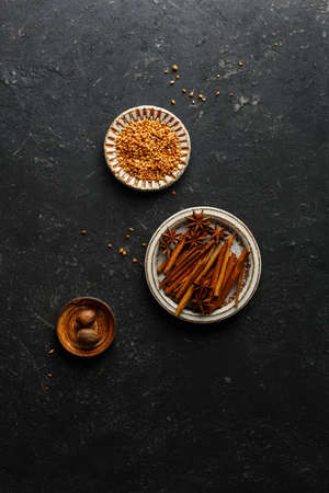 Cinnamon Sticks, star anise, nutmeg on a black background,の写真素材