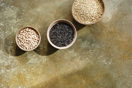 Different types of grains in bowls,wild rice, black bean and green buckwheat.の写真素材