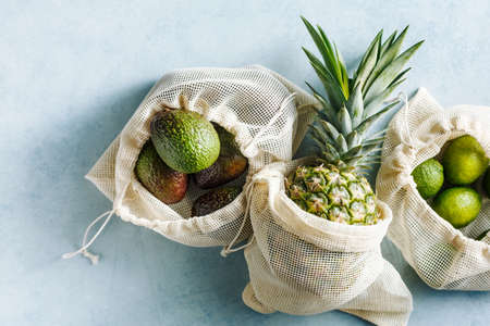 Cotton fabric bags with Green Fruits on blue background.の写真素材