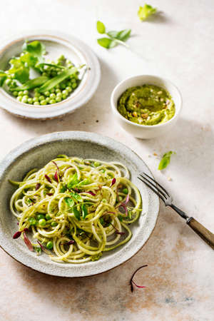 Zucchini pasta with peas and micro green sprouts. Healthy food.の写真素材