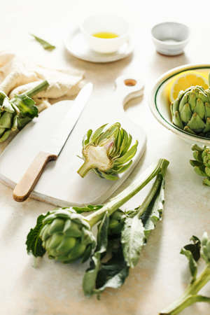 Raw artichokes in preparation for baking.の写真素材
