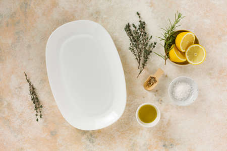 Empty white dish and cooking ingredientsの写真素材