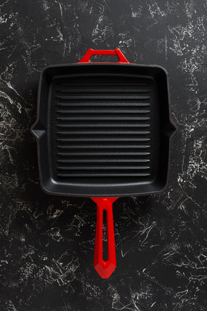 New grill pan on black textured backgroundの写真素材