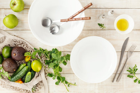 Empty bowls and ingredients for making a salad.の写真素材