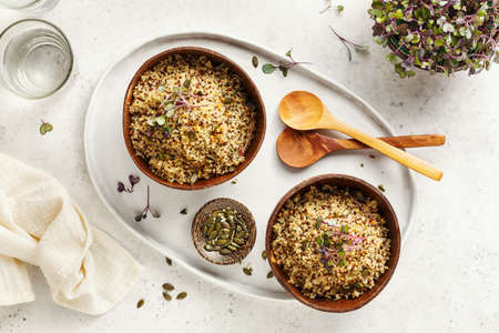 Healthy quinoa bowls with micro greens and pumpkin seeds.の写真素材