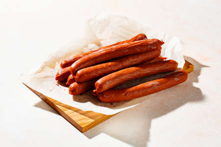 Smoked sausages with spices on a cutting board.の写真素材