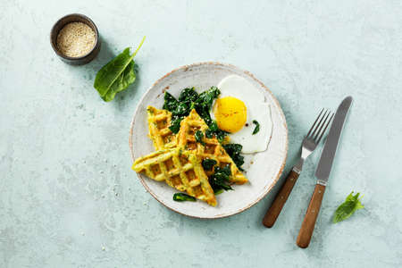 Spinach waffles with fried egg and cheeseの写真素材