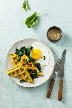 Healthy breakfast with egg, spinach and cheese waffles with herbs.の写真素材