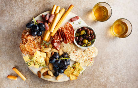 Antipasto plate with cheese, wine, grapesの写真素材