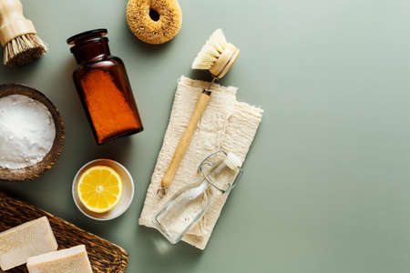 Concept of eco friendly home cleaning, baking soda, wooden brushes, vinegar, lemon, soap. Top view, flat lay.の写真素材