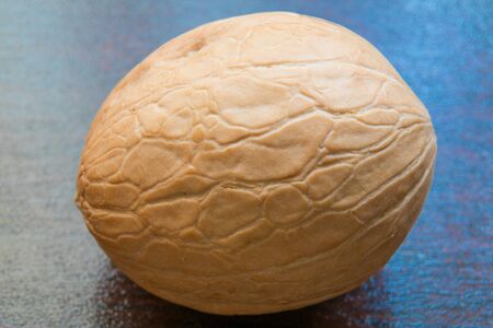 Whole one walnut on the table. Close up