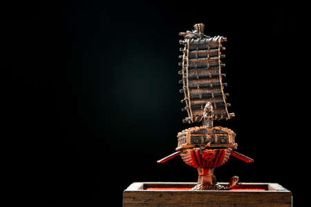 A small model of famous ancient Korean ironclad war ship. Korean turtle ship on a black background.の写真素材