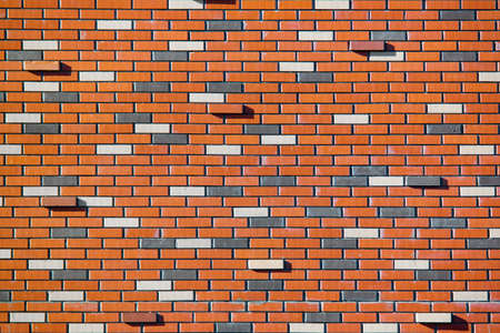 The street wall of multicolor bricks. Beautiful bricks background with protruding ones