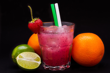 strawberry cocktail in glass on black backgroundの写真素材