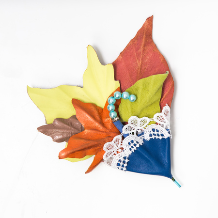 the decoration of leather. brooch in the shape of umbrella with flowers handmade on white backgroundの写真素材
