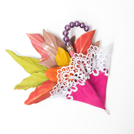 the decoration of leather. brooch in the shape of umbrella with flowers handmade on white backgroundの写真素材