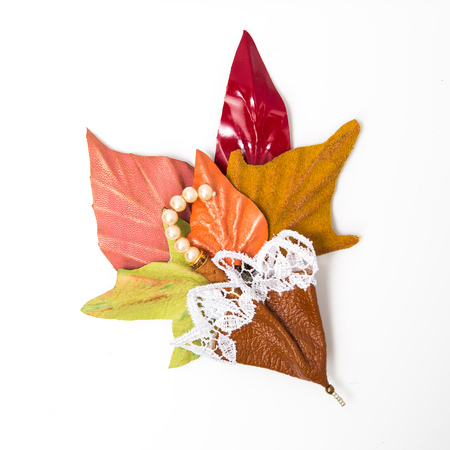 the decoration of leather. brooch in the shape of umbrella with flowers handmade on white backgroundの写真素材