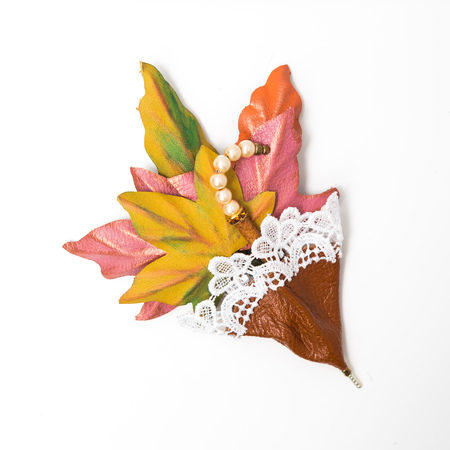 the decoration of leather. brooch in the shape of umbrella with flowers handmade on white backgroundの写真素材