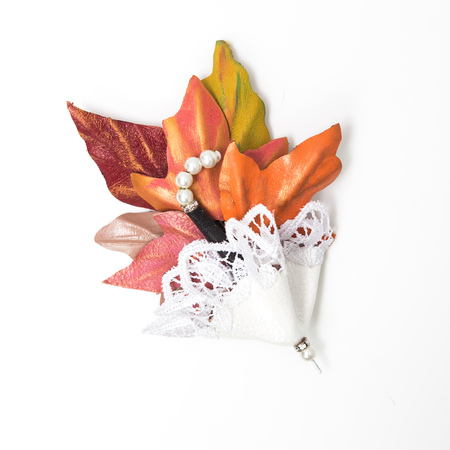 the decoration of leather. brooch in the shape of umbrella with flowers handmade on white backgroundの写真素材