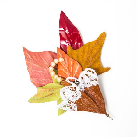 the decoration of leather. brooch in the shape of umbrella with flowers handmade on white backgroundの写真素材