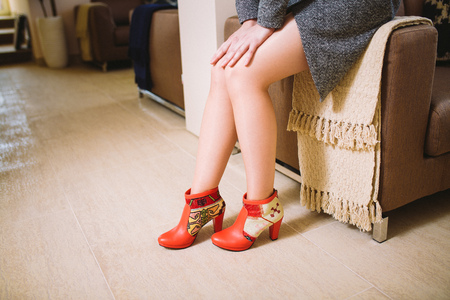 lookbook woman's legs in red leather boots handmade in the interiorの写真素材