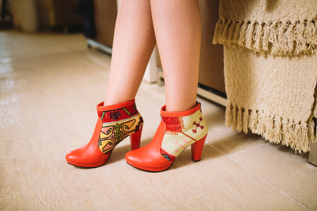 lookbook woman's legs in red leather boots handmade in the interiorの写真素材