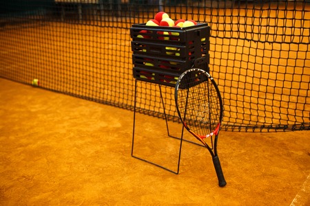 a lot of tennis balls to basket balls, tennis court clay. Grid for tennisの写真素材