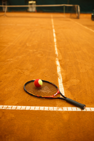 tennis racket and the ball. racket and tennis ball, yellow clay courtの写真素材