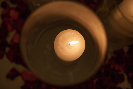 white candle in glass, red roses, romance is in the interiorの写真素材