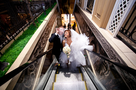a couple in love, wedding on the escalator at the Mall.の写真素材