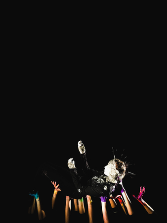 banner social concept. hands in paint raised up on a black background symbolizing fear, hope, struggle and a request for help. Place for text, copyright.の写真素材