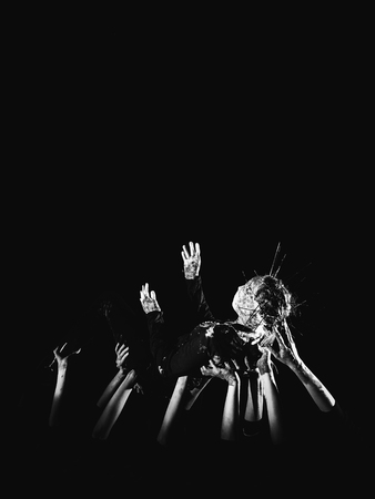 banner social concept. hands in paint raised up on a black background symbolizing fear, hope, struggle and a request for help. Place for text, copyright.の写真素材