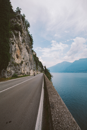 Driving on a scenic road along Lake Garda, Italy. Summer time. European vacation, living, life style, architecture and travel concept.の写真素材