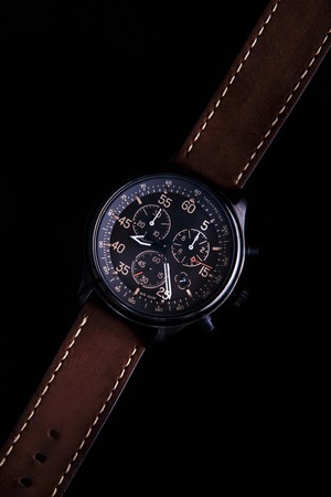 watch expedition arrow with brown leather strap on a black backgroundの写真素材