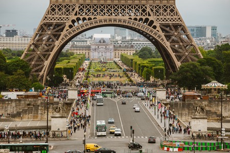 Paris, France July 24, 2017: Eiffel Tower close-up of a road with cars and buses traffic from a...