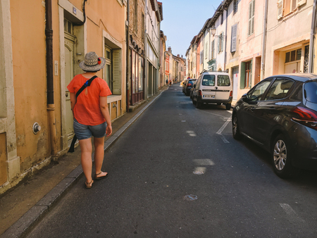 July 18, 2017 France city of Cluny, the region of the Burgundy: People tourists are walking along the old narrow street of the central part of the city in hot, sunny summer weather.のeditorial素材